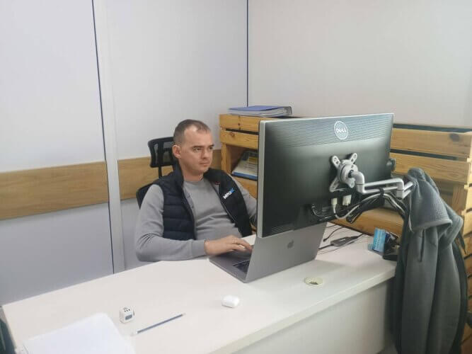 The author of article on AI software development Ruslan Moroz working in his office